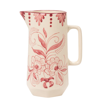 view of other side of An off-white ceramic pitcher decorated with a dusty red floral pattern