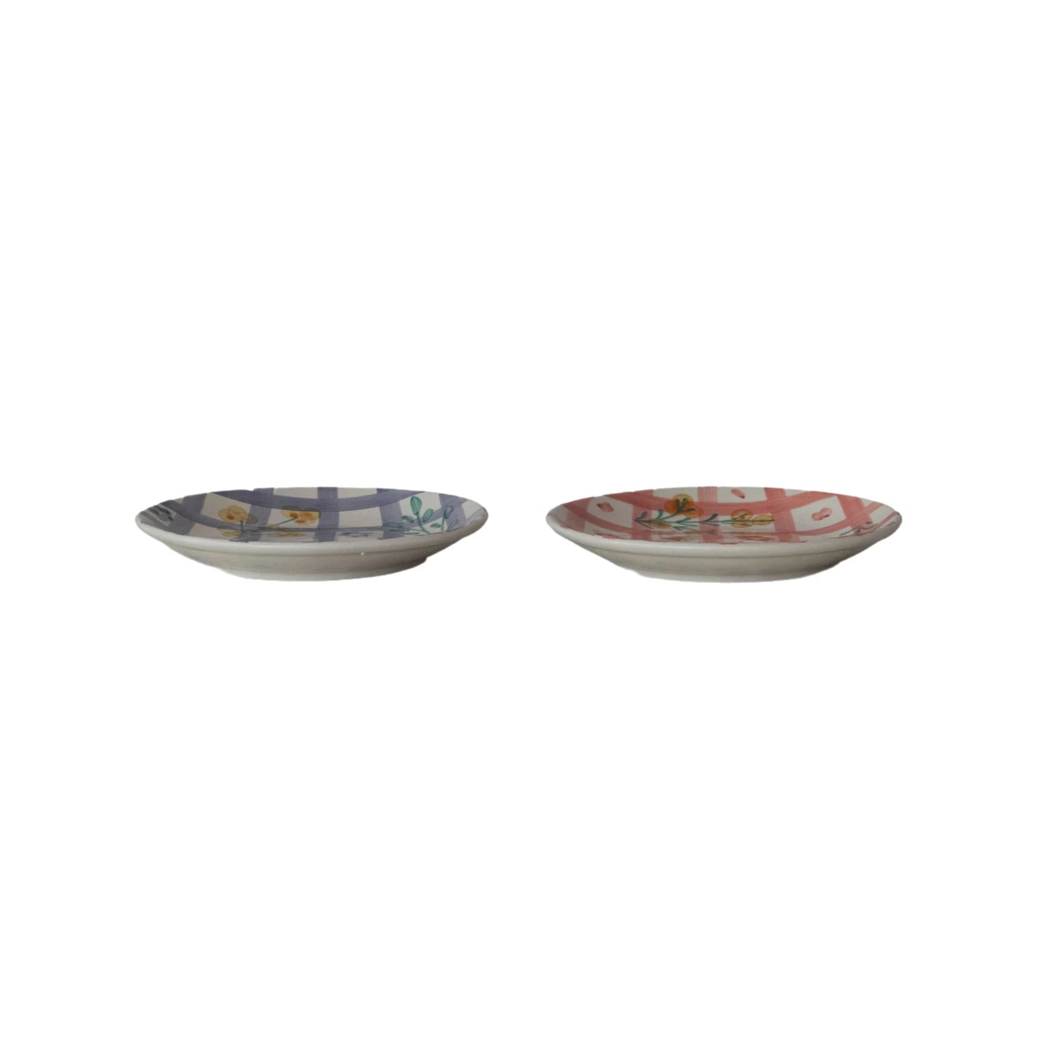 side view of plates with plaid and floral design on a white background