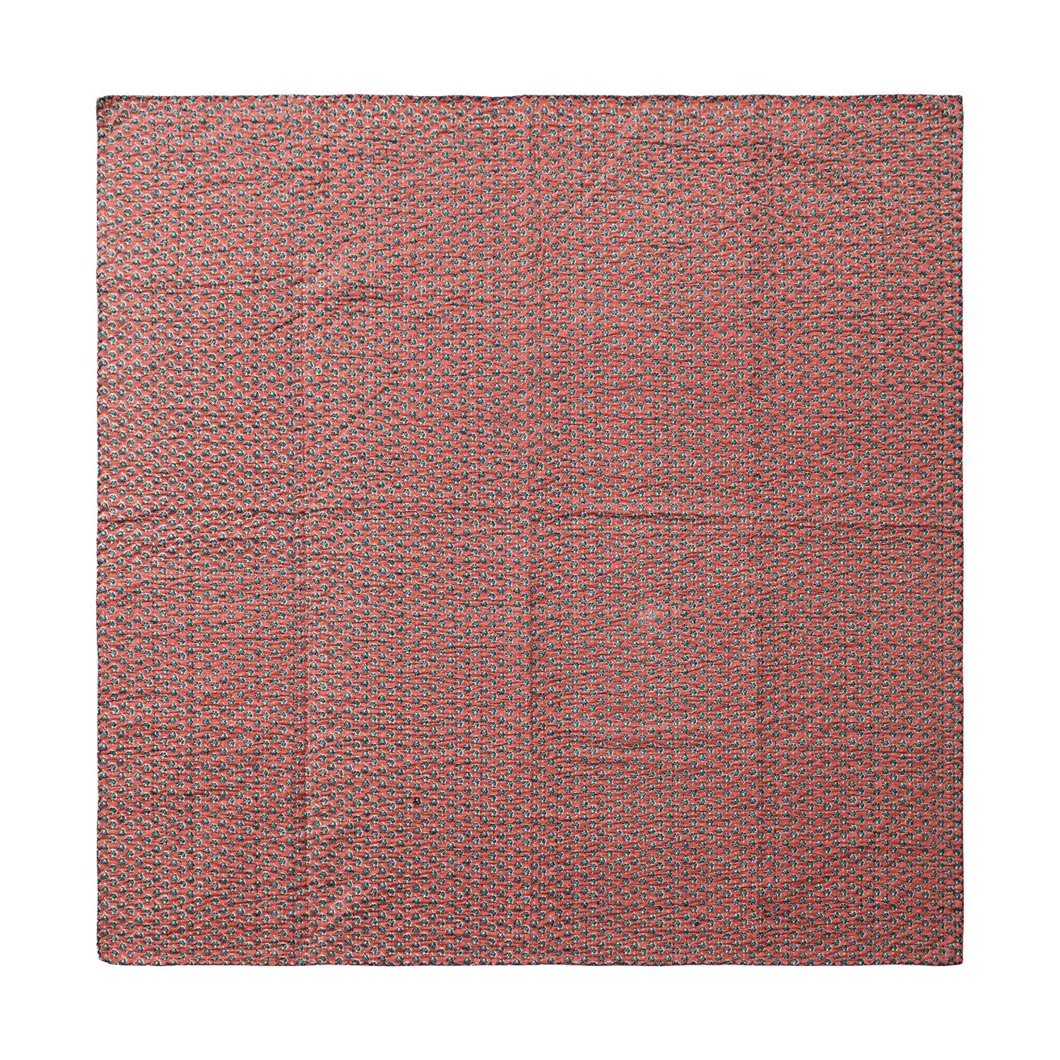 red side of the kantha stich blanket laying flat on a white surface