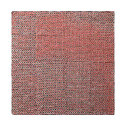 red side of the kantha stich blanket laying flat on a white surface