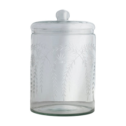 Clear glass jar with leaf pattern and lid on a white background