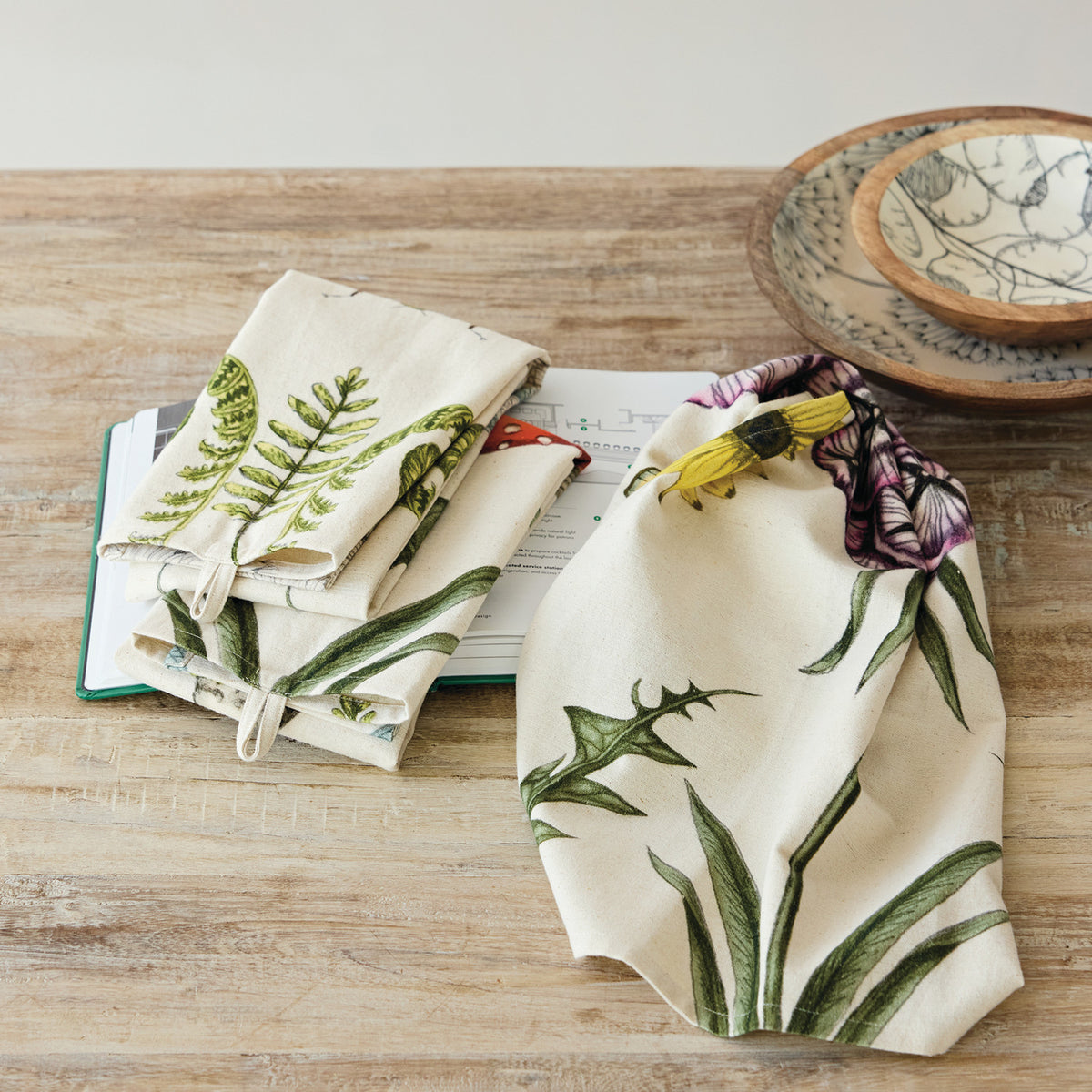 2 towels draped on a wooden table