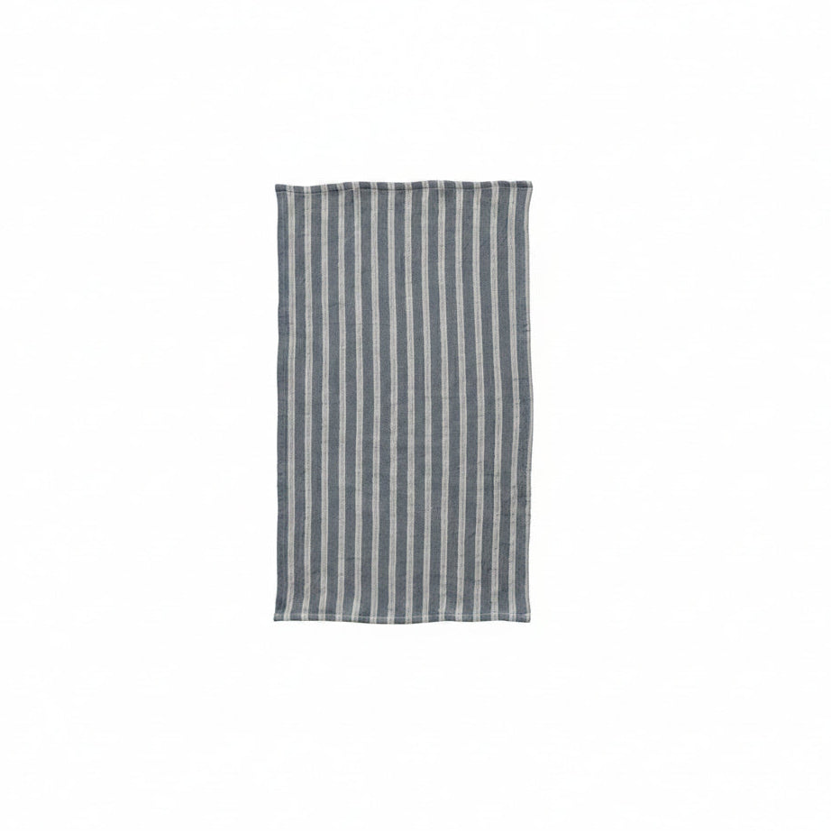 blue towel with off-white stripes laying flat on a white background