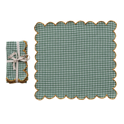 Green checkered napkin laying flat  and matching folded napkin set shown a on a white background