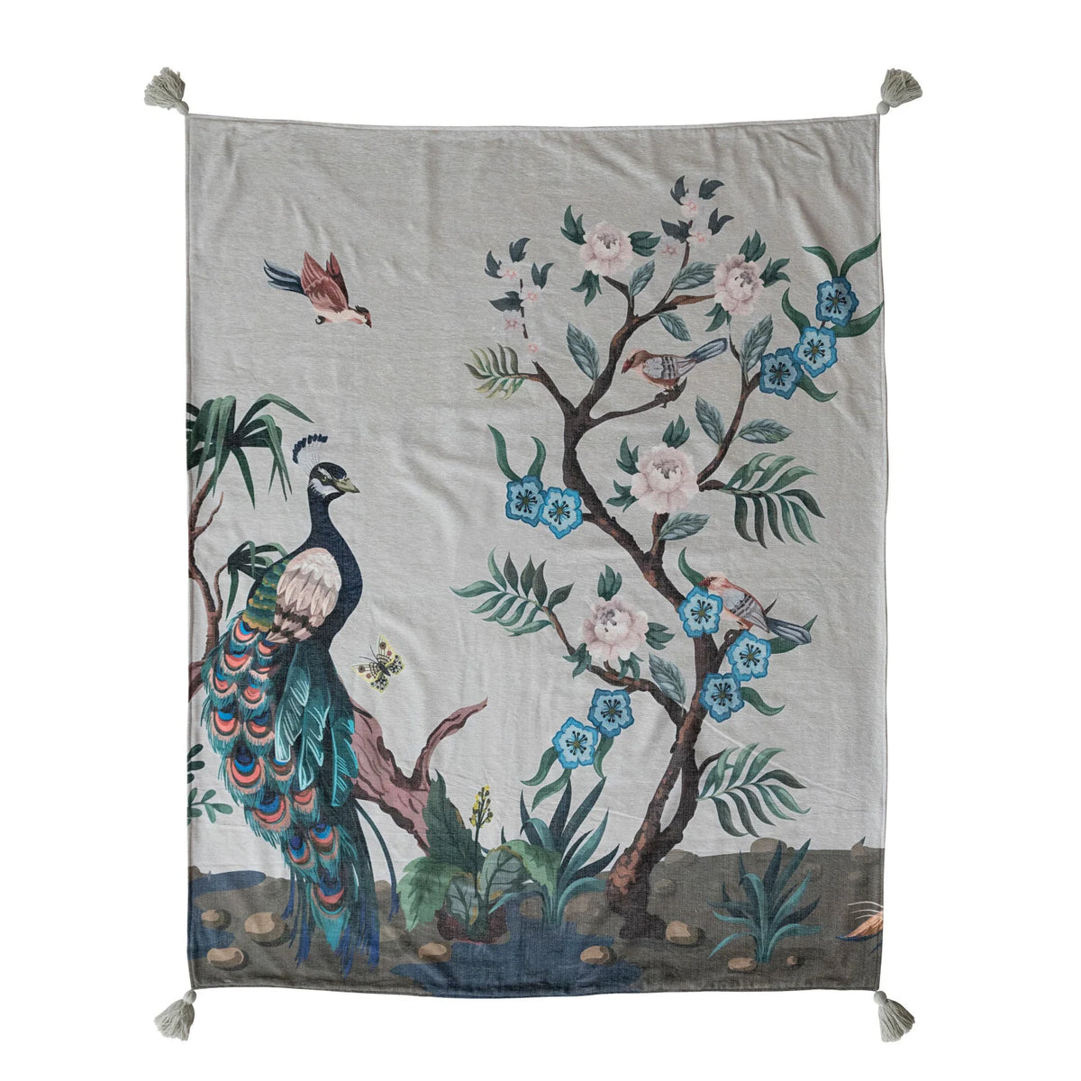 throw blanket with design of a peacock on left and flowering tree with birds on right laying flat on a white background