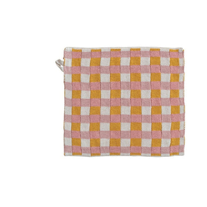 Checkered dishcloth with pink, yellow, and white pattern on a white background