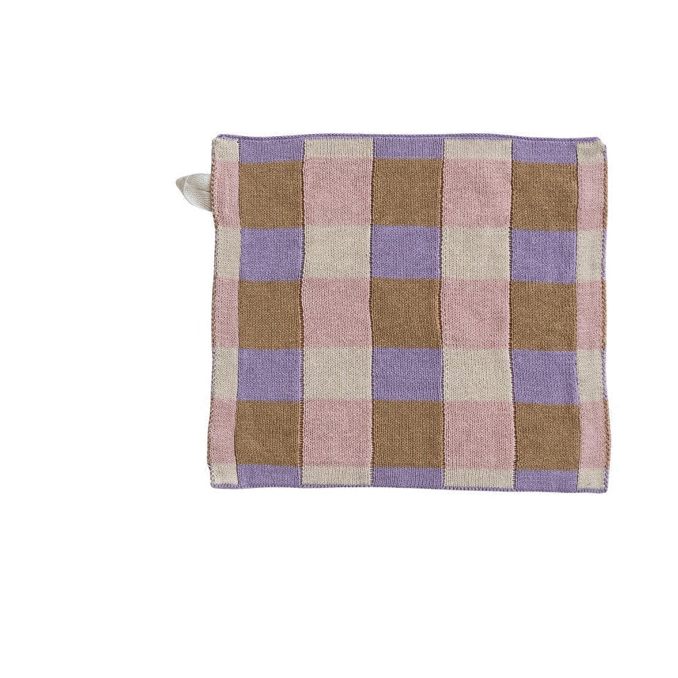 checkered dishcloth with pink tan and purple design on a white background
