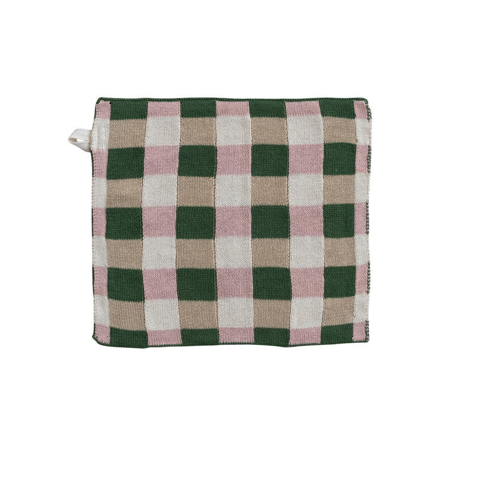 Checkered dishcloth  with green, pink, and beige pattern on a white background