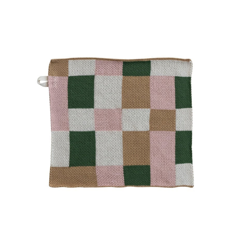 Checkered dishcloth with green, pink, and brown pattern on a white background