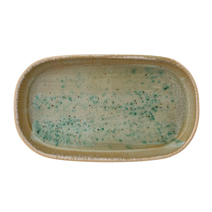 Rectangular ceramic tray with speckled green and beige design on a white background