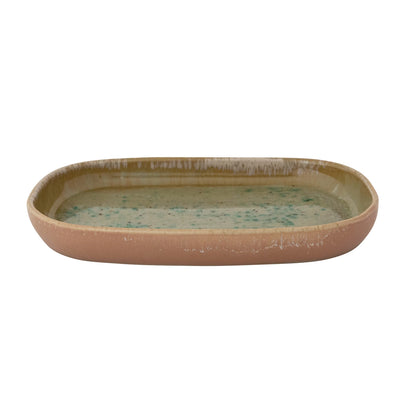 side view of Ceramic plate with a speckled design on a white background