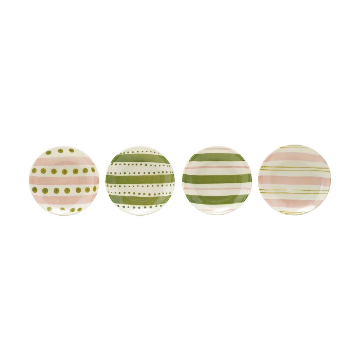 assorted small round plates with pink and green dots and stripes in a row on a white background