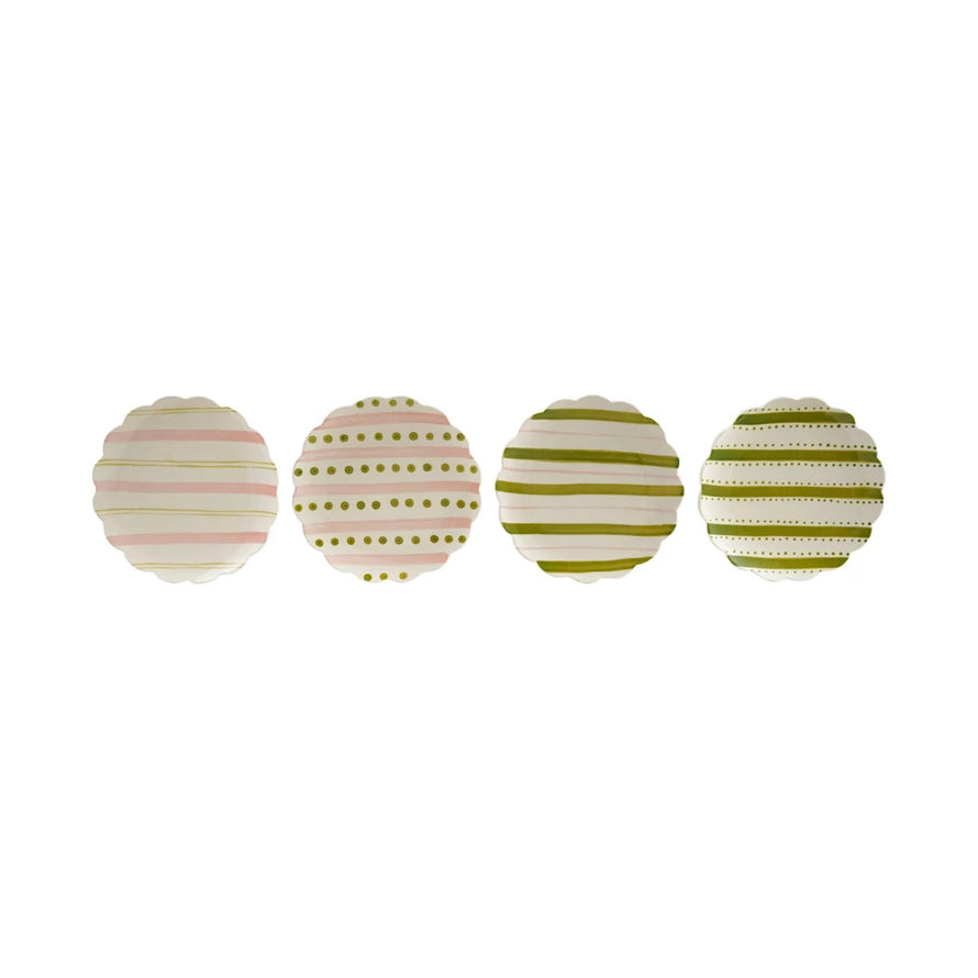 row of ceramic plates with pink and green striped and polka dot patterns shown on a white background