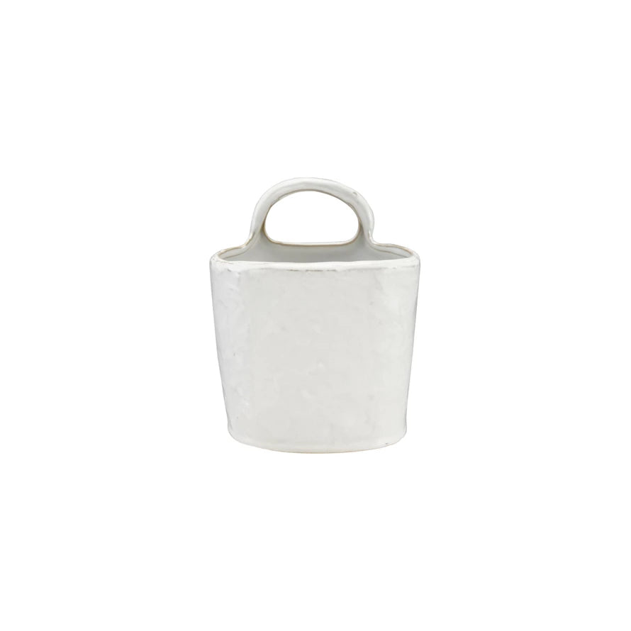 White ceramic container with handle on a white background