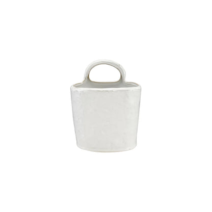 White ceramic container with handle on a white background