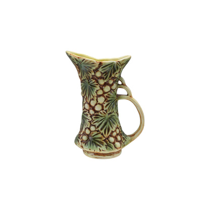 embossed Ceramic pitcher with grape and leaf pattern on a white background
