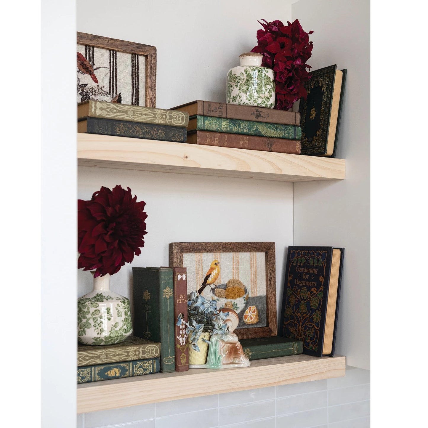 book shelf arranged with books and other decorative items