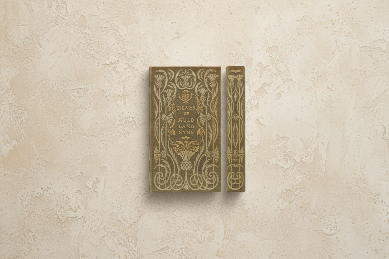 brown book cover and spine with scrolling gold design and titled "the days of auld lang syne" printed in the center of cover, shown on a beige plaster surface