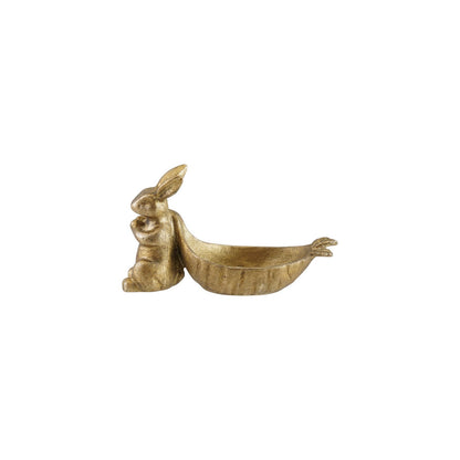 small golden rabbit with carrot shaped dish on a white background