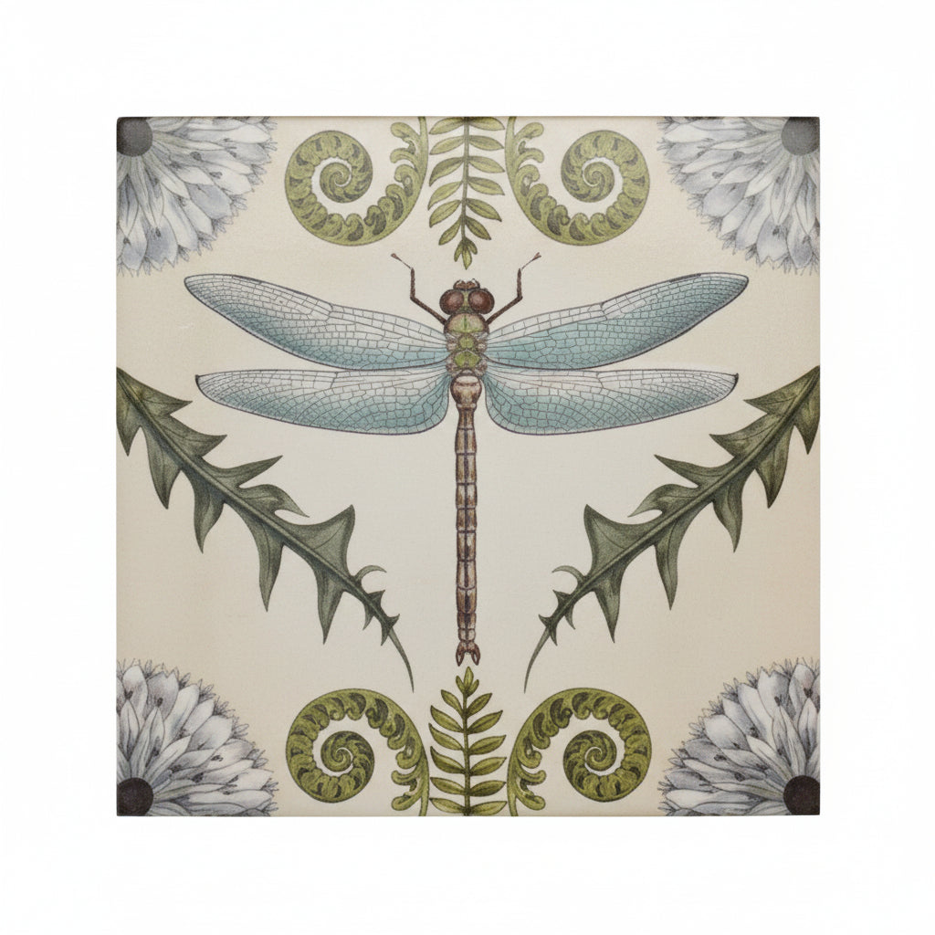 matchbox with blue dragonfly in the center and greenery around it