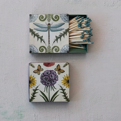 2 match boxes on a plaster background one open to show matches