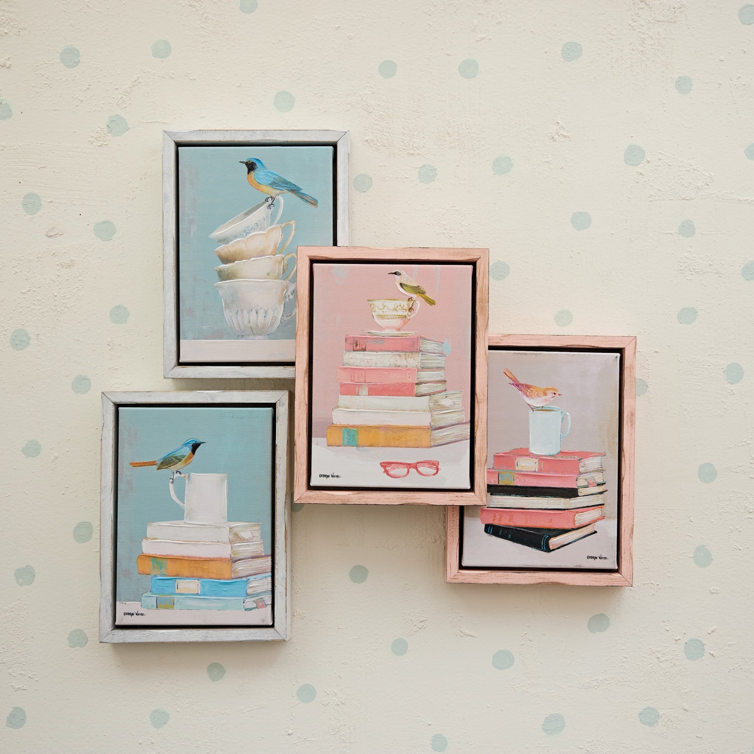 four framed illustrations of birds and books on a wall with blue polka dot pattern