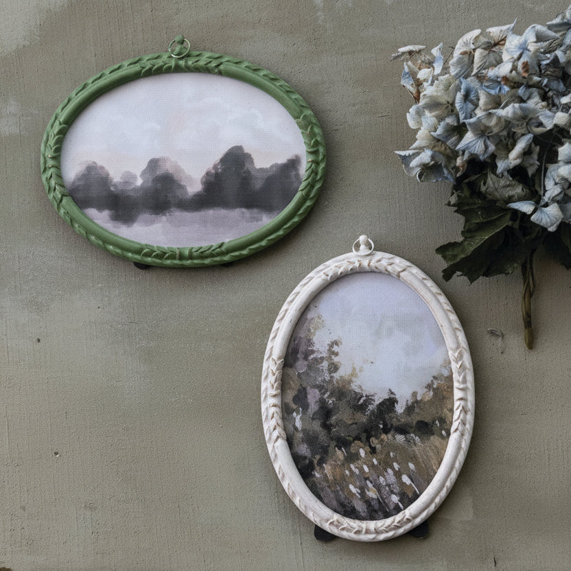 2 oval frames, one cream and one green shown on a grey background with a drier flower on the right