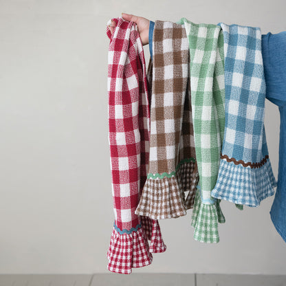 person holding 4 different colors of hand towels over their arm
