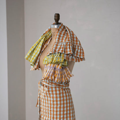 3 assorted checked tea towels draped over a muslin mannequin