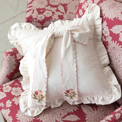 Ruffled  Pillow with Scalloped Bow set  on a decorative pink floral arm chair