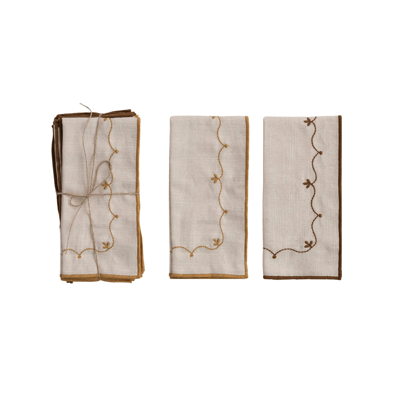 embroidered napkins with decorative patterns folded on a white background