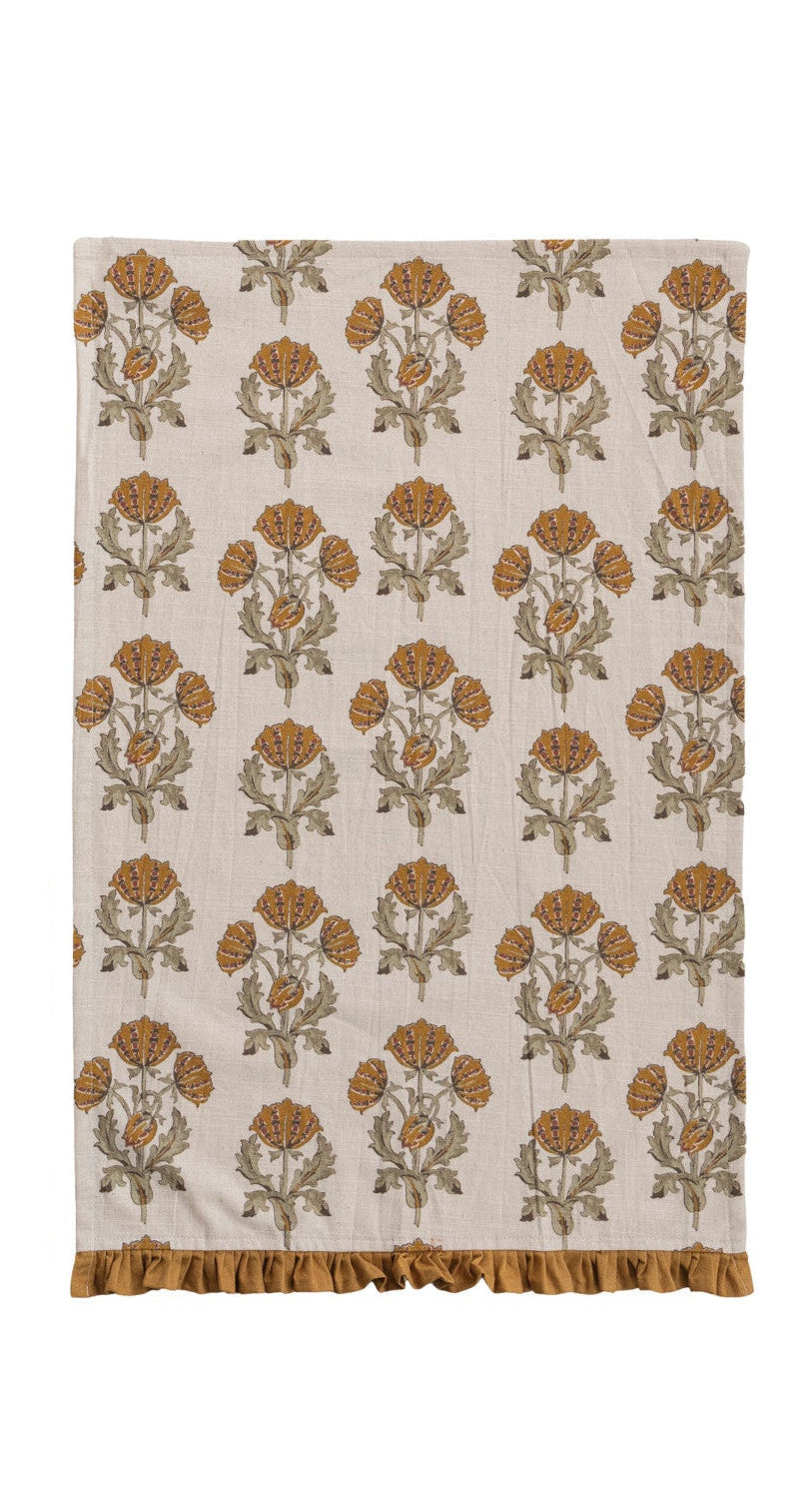 mustard yellow block print towel with floral design and mustard-colored ruffled hem
