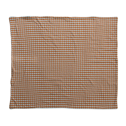 orange and light blue gingham blanket laying flat on a white background