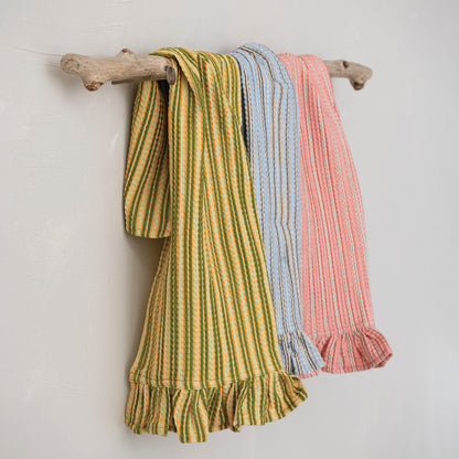 other side of 3 assorted striped tea towels hanging on a branch against a white wall