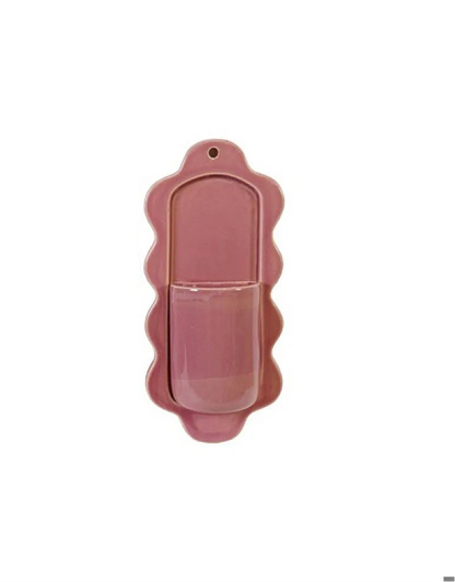 pink ceramic wall pocket shown on a white background
