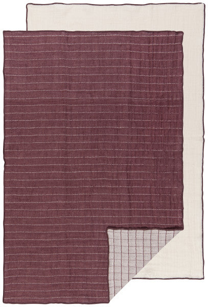 one plum and one off-white dishtowel laying flat.