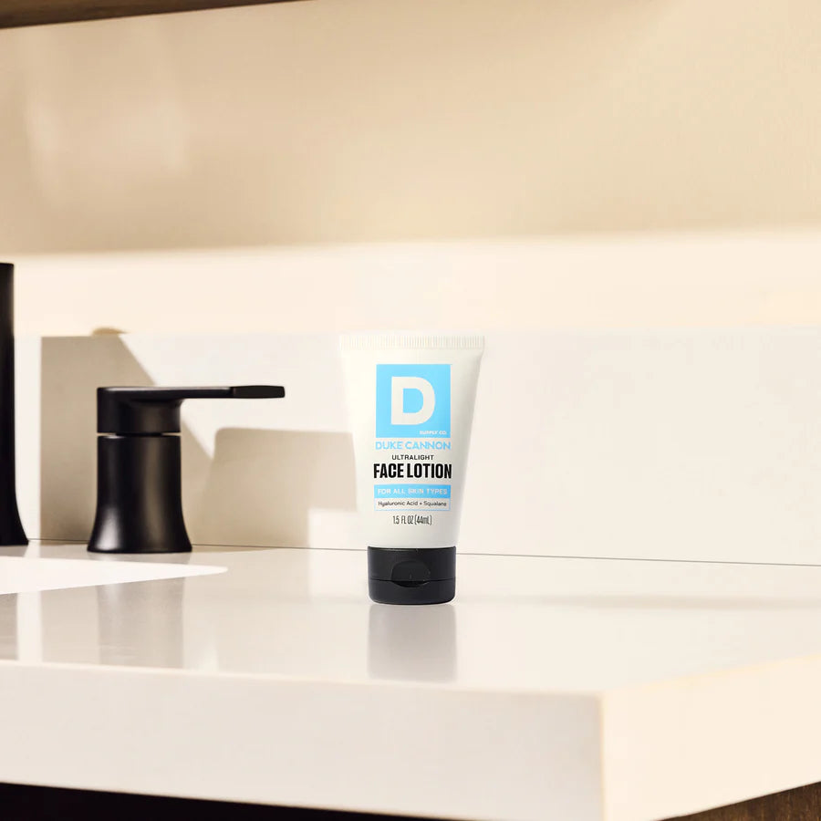 Tube of face lotion on a bathroom counter with a mirror in the background