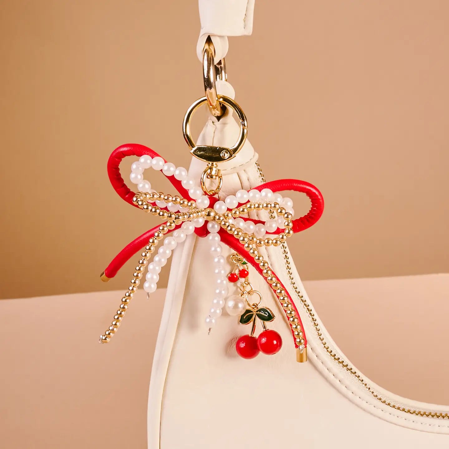 cherry bliss Layered Bows Bag Charm hung on a white purse