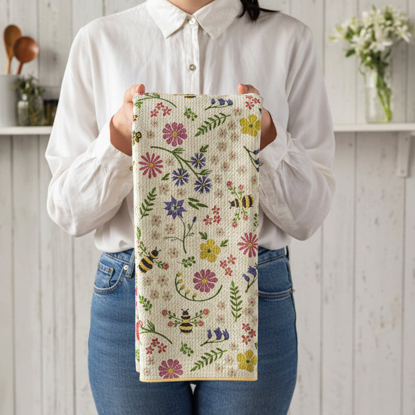 bee garden towel being held by a person wearing jeans and white blouse