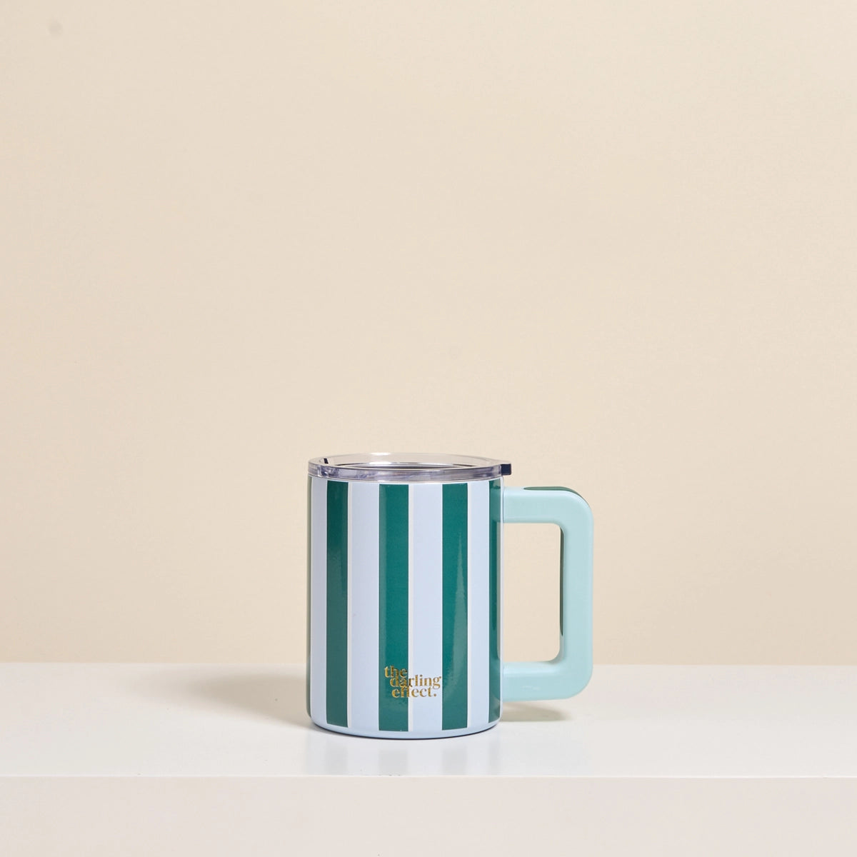Striped mug with a handle on a beige background