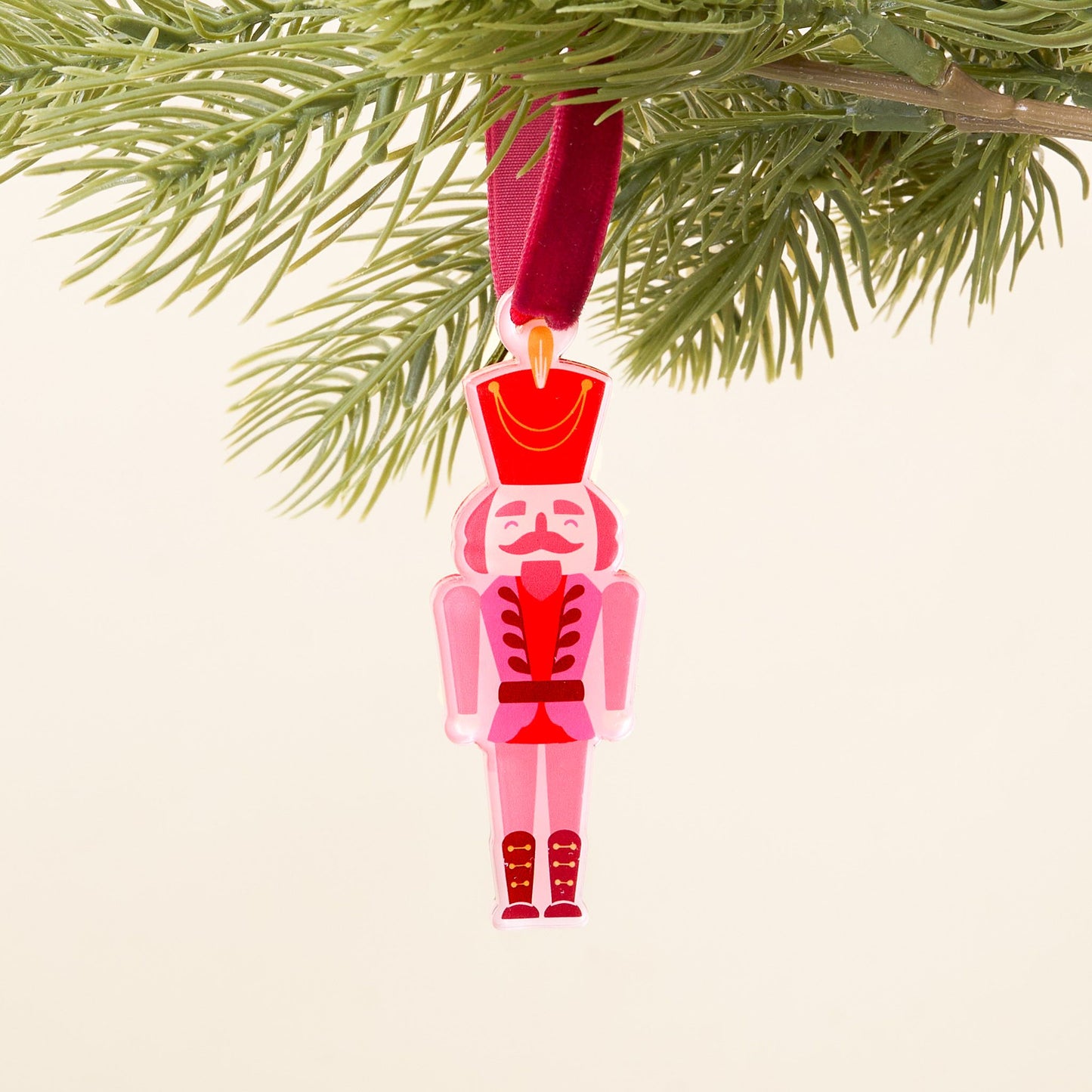 red and pink nutcracker ornament