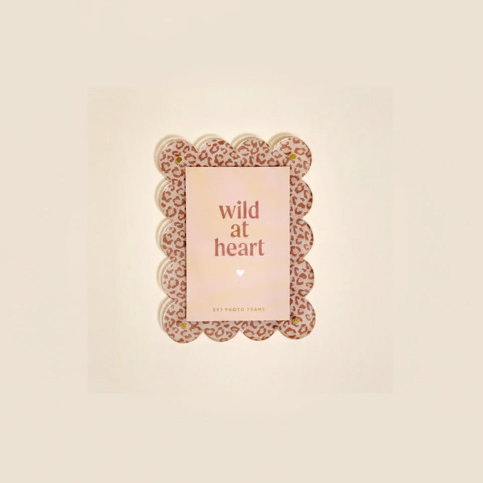 Leopard print photo frame with 'wild at heart' text insert card shown on a beige background