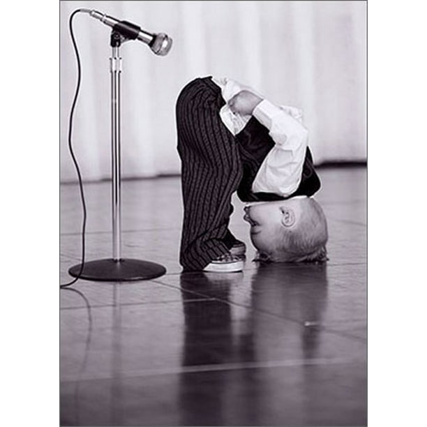 front of card is a little boy bending over with his rear facing a microphone on stage in black and white