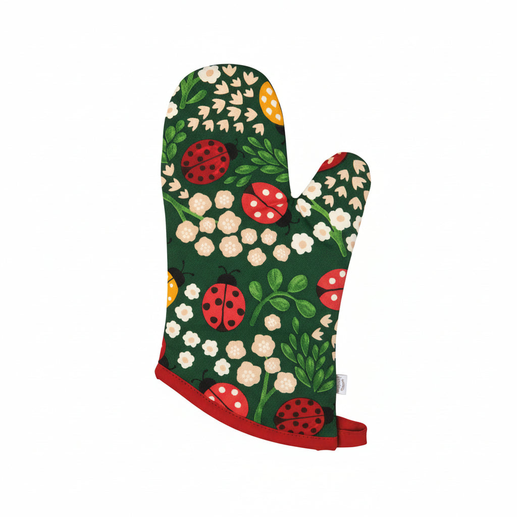 2 green ovenmits with white and peach flowers and red and yellow ladybugs on them