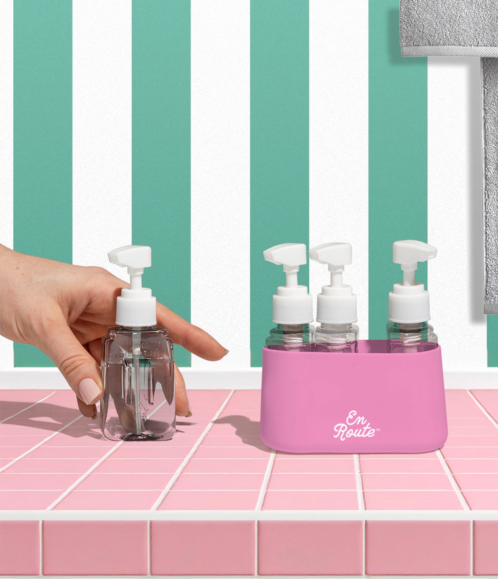Bon Voyage Travel Bottle Set in pink being used on a bathroom counter