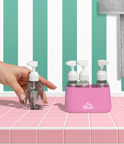 Bon Voyage Travel Bottle Set in pink being used on a bathroom counter