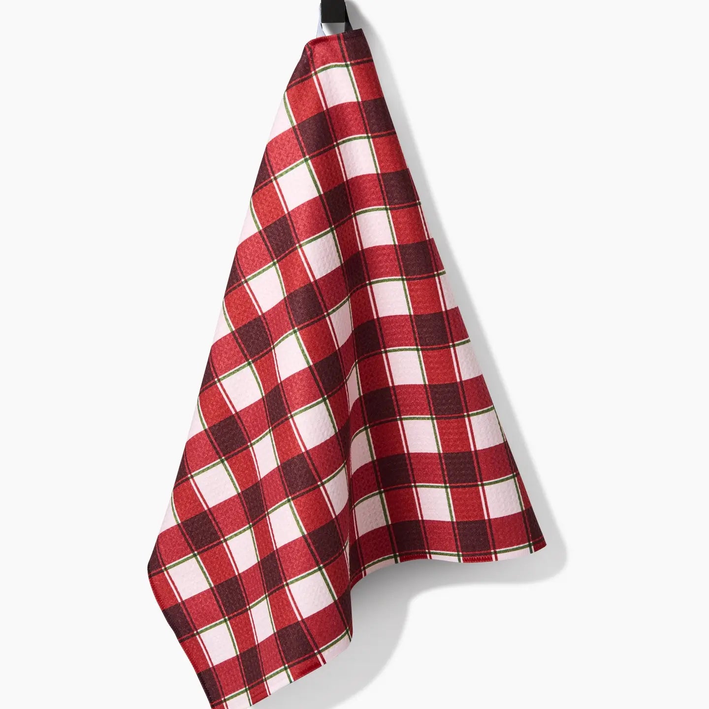 Jingle Plaid Tea Towel draped on a hook
