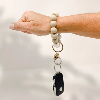person wearing oatmilk latte Hands-Free Keychain Wristlet on their wrist