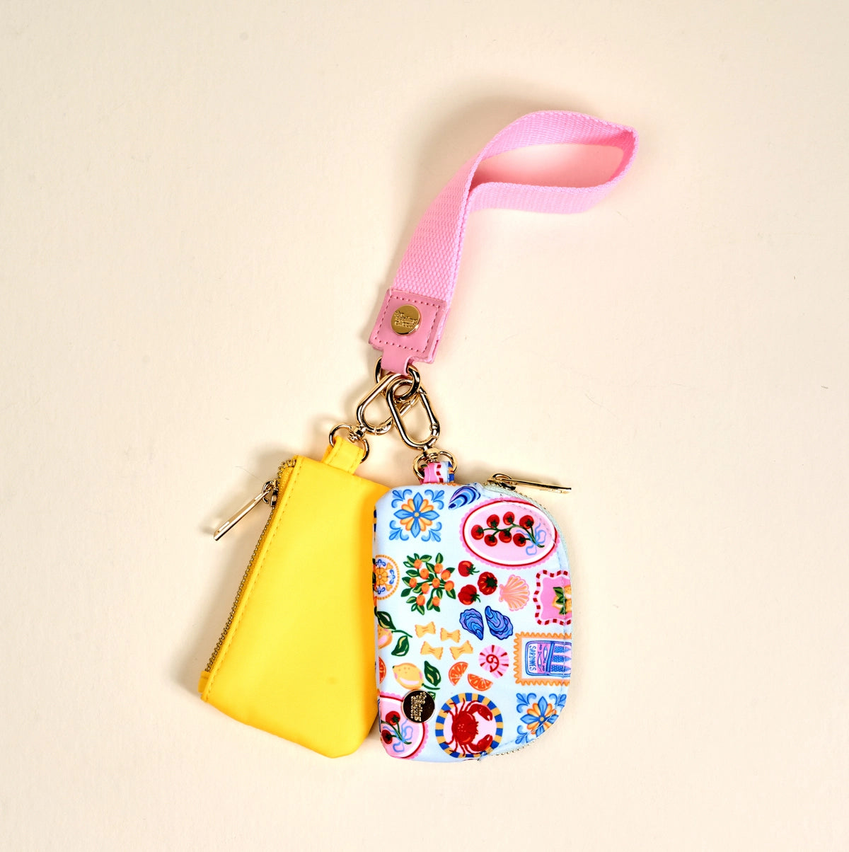 Colorful keychain with a yellow pouch and floral design on a beige background