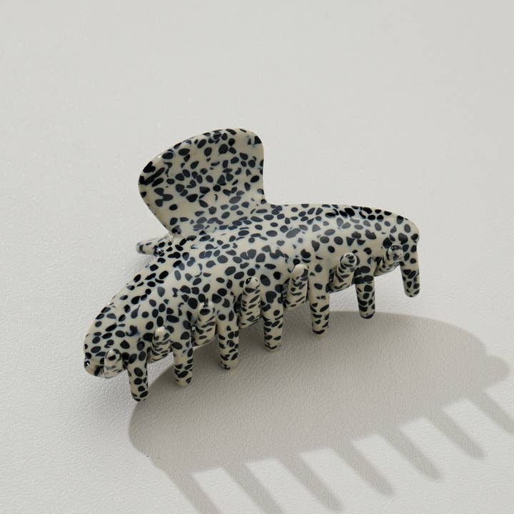 beige claw clip with black speckled pattern